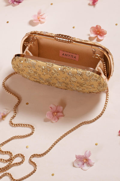AMYRA Elan gold silk capsule clutch