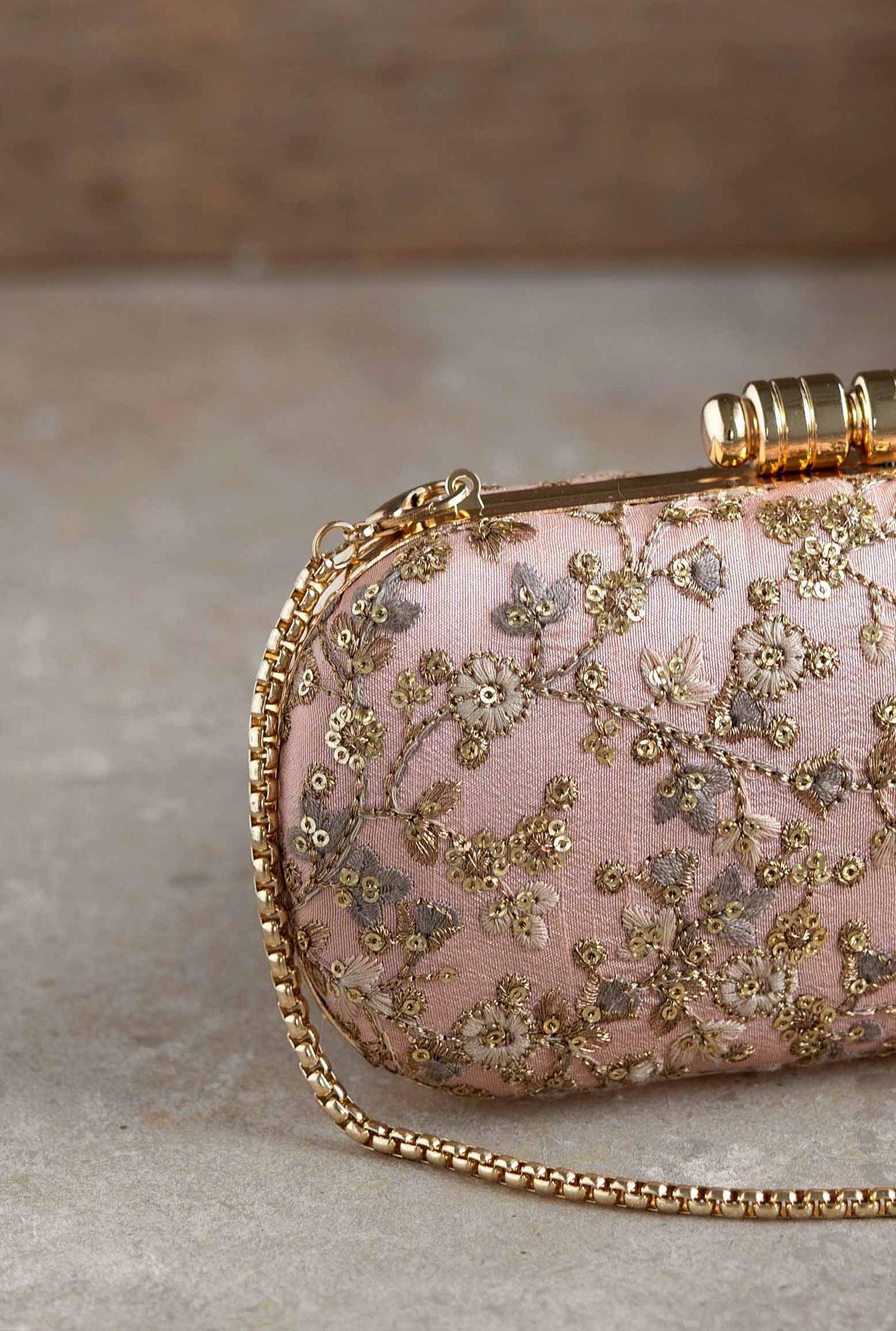 Amyra elan peach capsule clutch