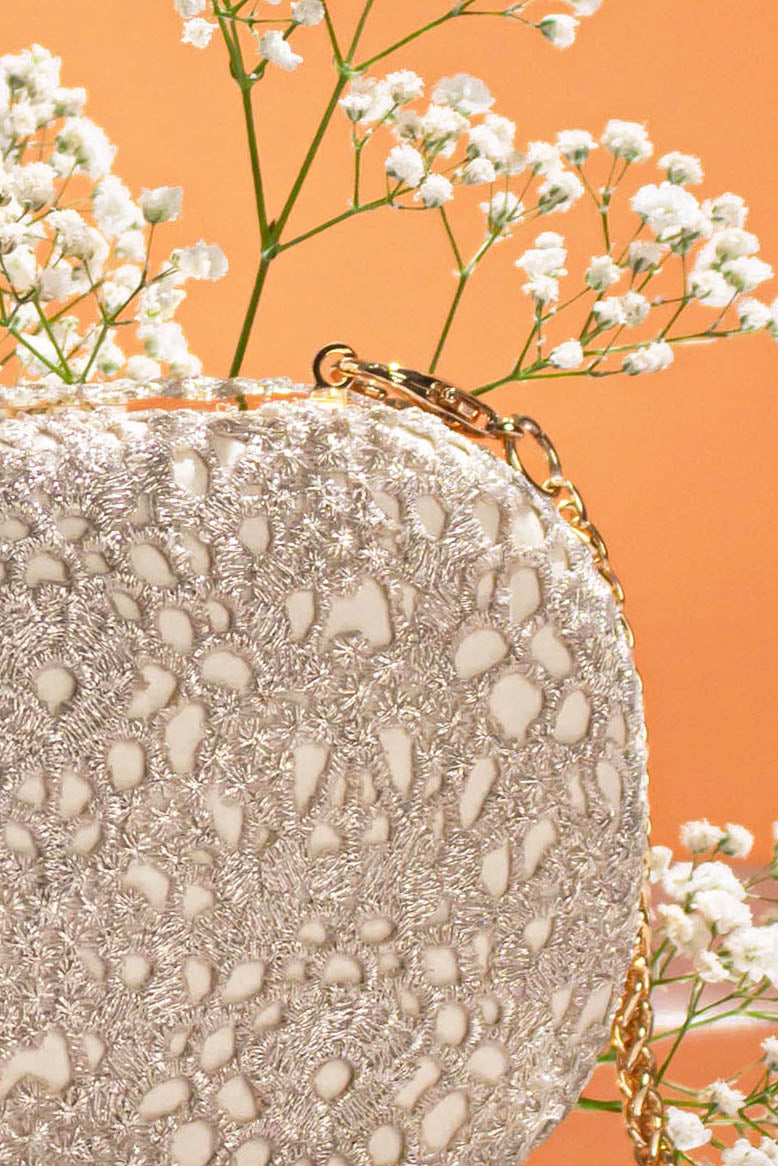 AMYRA Ivory Cutwork Capsule Clutch